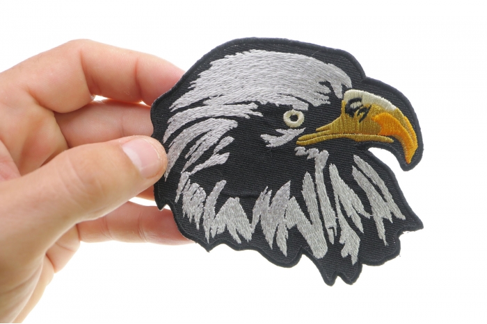 White Eagle Facing Right Iron on Patch shown on hand for size comparison