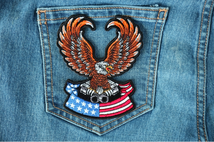 Brown Eagle Patch sitting on American Flag Patch for Jackets shown on jeans