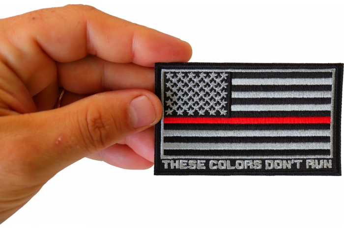 Thin Red Line American Flag These Colors Don't Run Patch shown on hand for size comparison