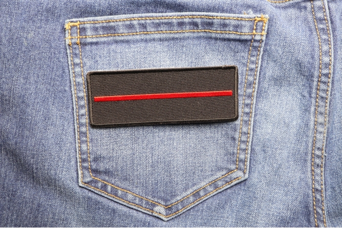 Thin Red Line Patch For Firefighters shown on jeans