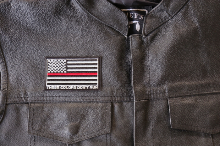 Thin Red Line American Flag These Colors Don't Run Patch - 3.5x2.1 inch. Embroidered Iron on Patch shown on leather vest