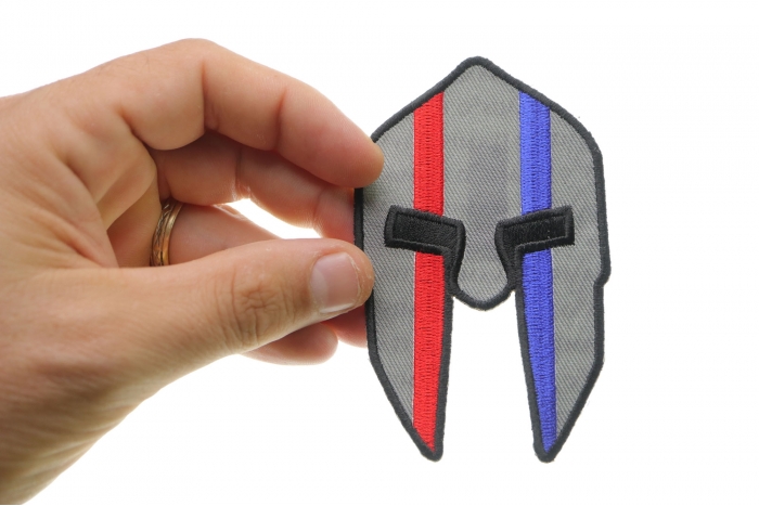 Spartan Helmet Red and Blue First Responder Iron on Patch shown on hand for size comparison