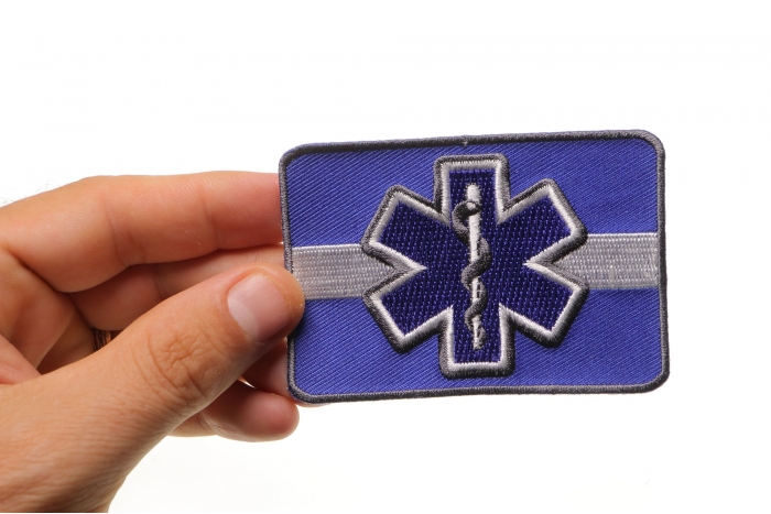 Thin White Line Blue Star Of Life Iron on Patch For EMS shown on hand for size comparison
