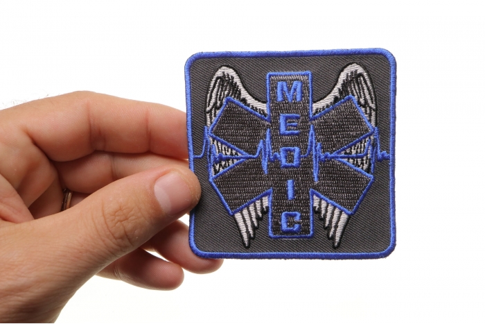 Winged Medic Iron on Patch shown on hand for size comparison