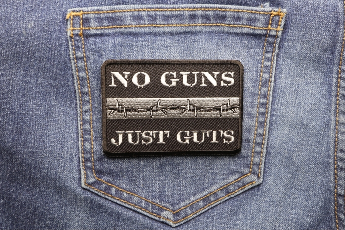 No Guns Just Guts Thin Silver Line Patch For Correctional Officers shown on jeans