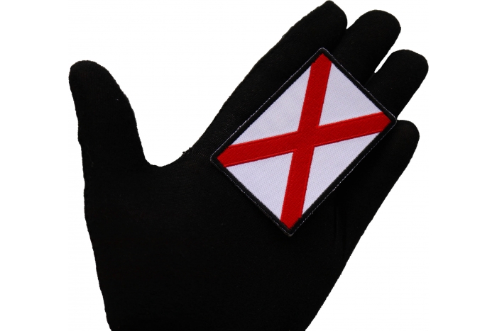 Alabama State Flag Patch shown on hand for size comparison