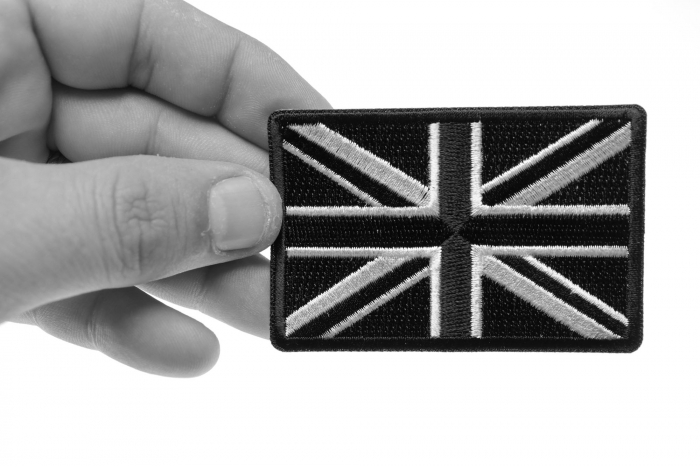 Black and White UK Flag Patch shown on hand for size comparison