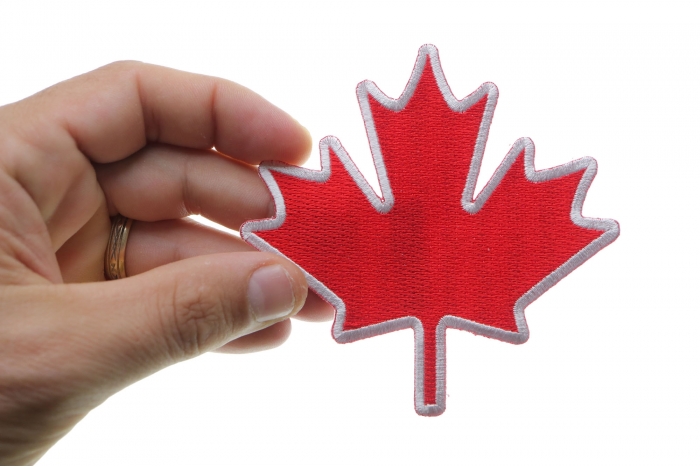 Canada Maple Leaf Iron on Patch shown on hand for size comparison