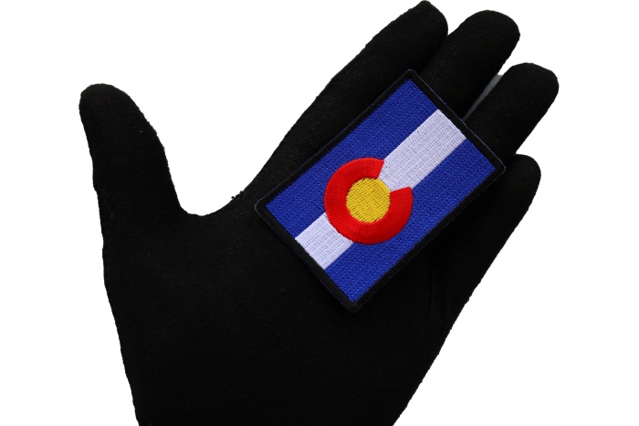 Colorado State Flag Patch shown on hand for size comparison
