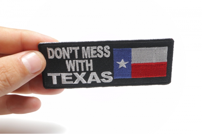 Don't Mess With Texas Patch With Flag shown on hand for size comparison