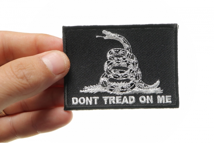 Don't Tread On Me Black White Patch shown on hand for size comparison