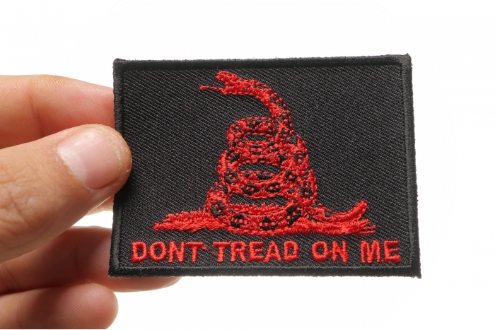 Don't Tread On Me Gadsden Flag Red Over Black Patch shown on hand for size comparison