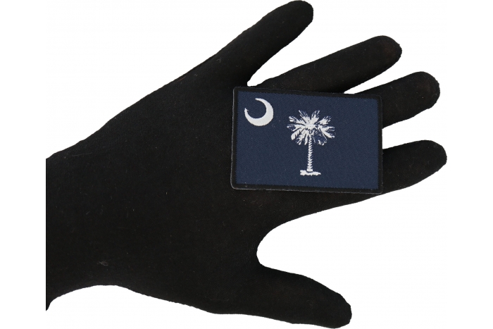 Historical South Carolina Flag Iron on Patch shown on hand for size comparison