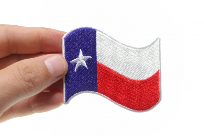 Texas Waving Flag White Border Patch shown on hand for size comparison
