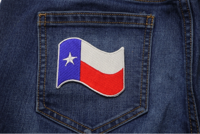Texas Waving Flag White Border Patch shown on jeans
