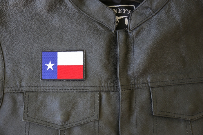 Black Border Texas Flag Patch - 3x2 inch - Embroidered Iron on Patch shown on leather vest