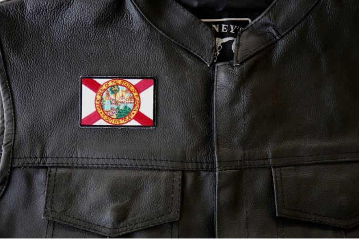 Florida Flag Patch - 3x2 inch. Embroidered Iron on Patch shown on leather vest