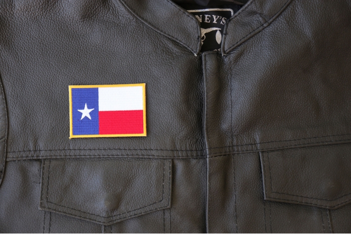 Gold Border Texas Flag Patch - 3x2 inch - Embroidered Iron on Patch shown on leather vest