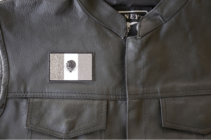 Mexican Flag in Black White and Gray - 3x2 inch. Embroidered Iron on Patch shown on leather vest