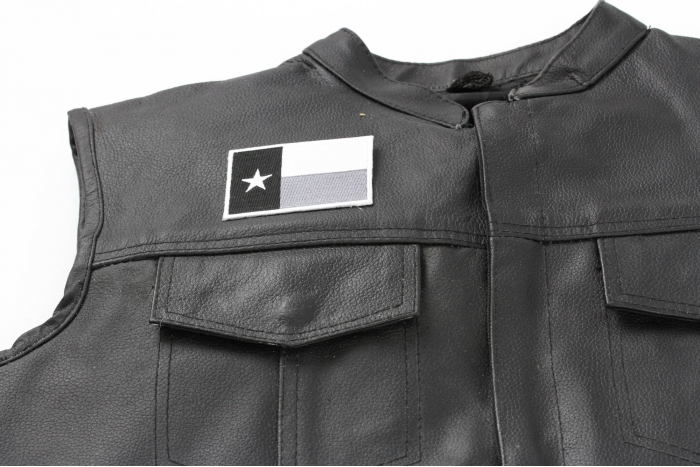 Monochrome Texas Flag Patch - 3x2 inch. Embroidered Iron on Patch shown on leather vest