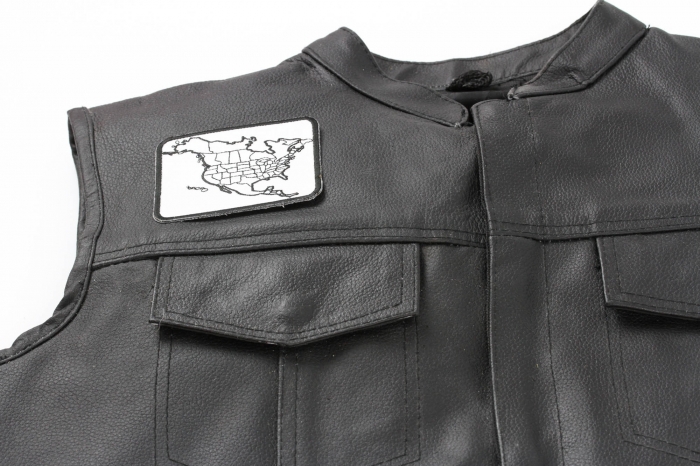 North America Color In Patch Small - 3.75x2.75 inch. Embroidered Iron on Patch shown on leather vest