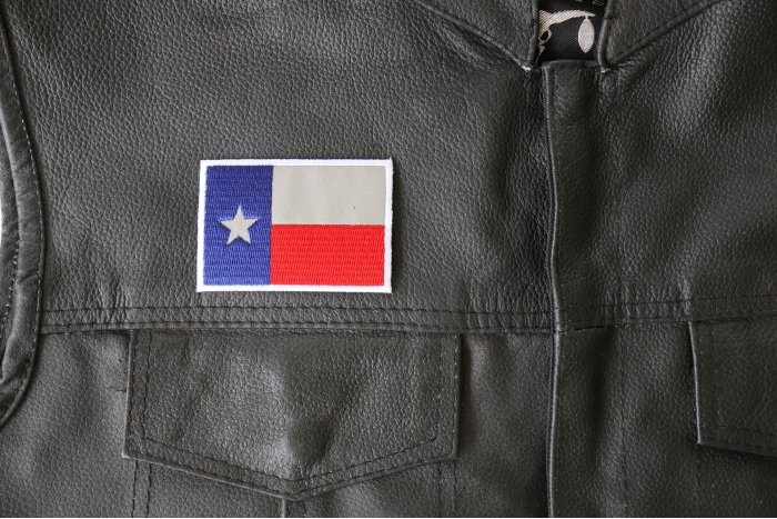 Reflective Texas Flag Patch - 3x2 inch - Embroidered Iron on Patch shown on leather vest
