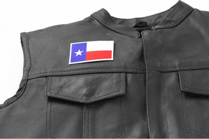 Texas Flag White Border Patch - 3x2 inch. Embroidered Iron on Patch shown on leather vest