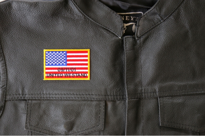 United We Stand 91101 Flag Patch - 3x2 inch. Embroidered Iron on Patch shown on leather vest