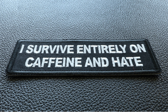 I survive entirely on Caffeine and Hate Funny Iron on Patch diagonal view