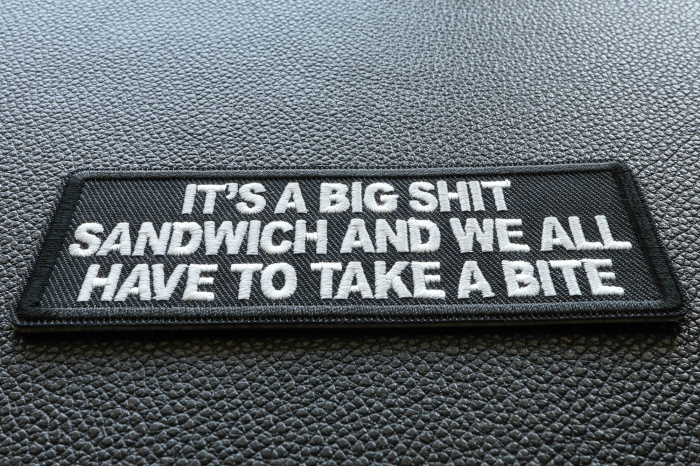 It's a Big Shit Sandwich and We all have to take a Bite Funny Iron on Patch diagonal view
