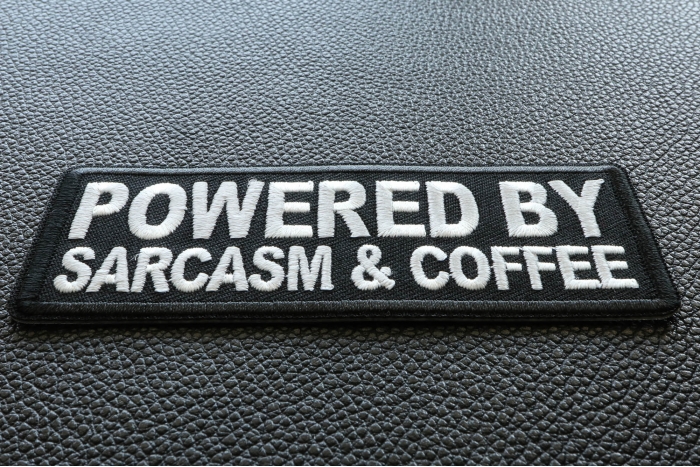 Powered By Sarcasm and Coffee Funny Iron on Patch diagonal view