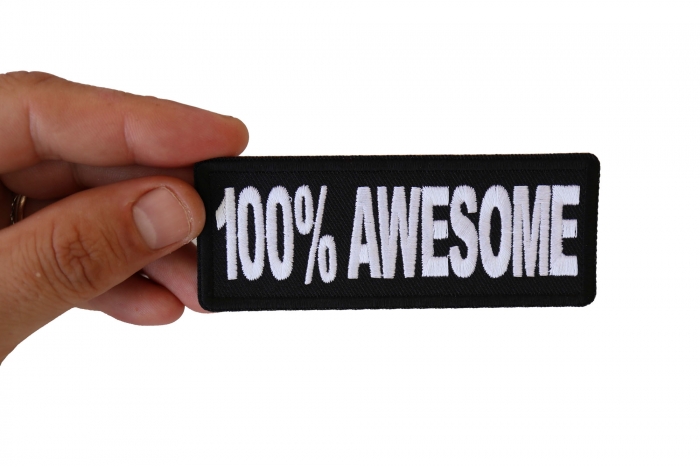 100% Awesome Funny Iron on Patch shown on hand for size comparison