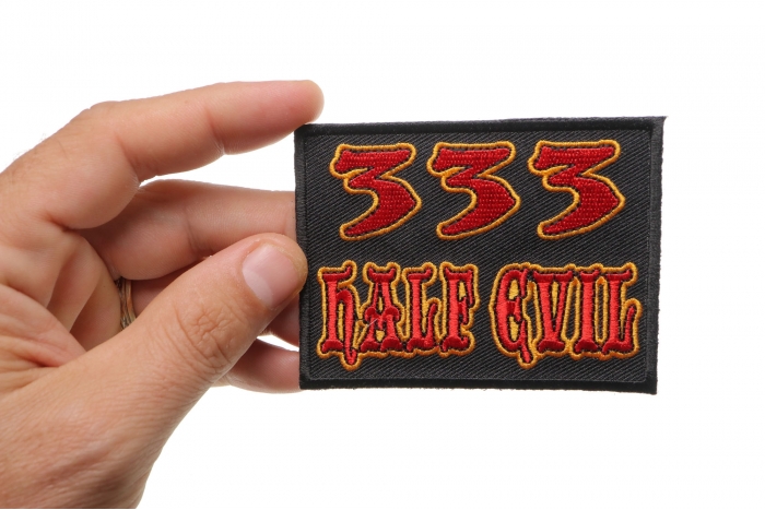 333 Half Evil Funny Iron on Patch shown on hand for size comparison