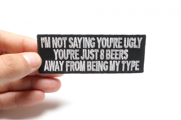 8 Beers Away From Being My Type Funny Saying Patch shown on hand for size comparison