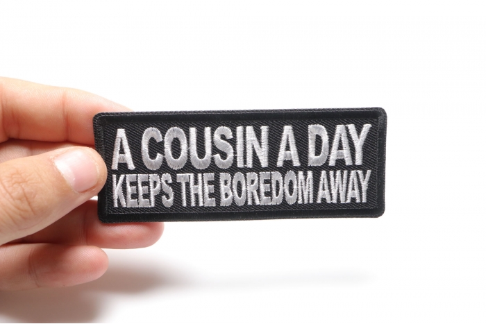 A Cousin a Day keeps the Boredom Away Patch, Funny Saying Patches shown on hand for size comparison