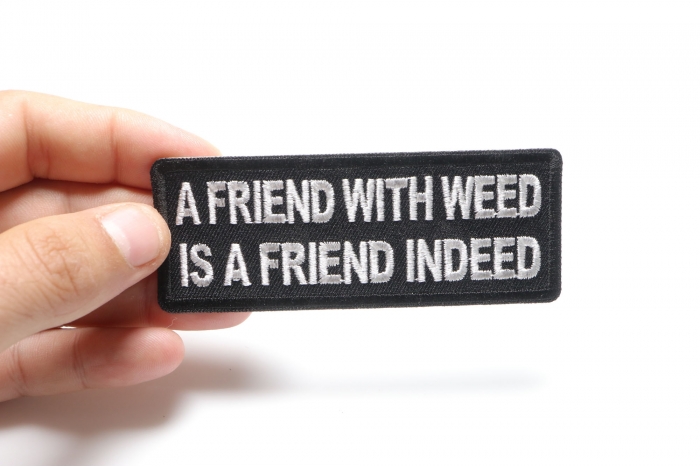 A Friend with Weed is a Friend indeed Funny Iron on Patch shown on hand for size comparison