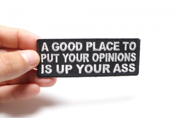 A Good Place To Put Your Opinions Is Up Your Ass Funny Iron on Patch shown on hand for size comparison