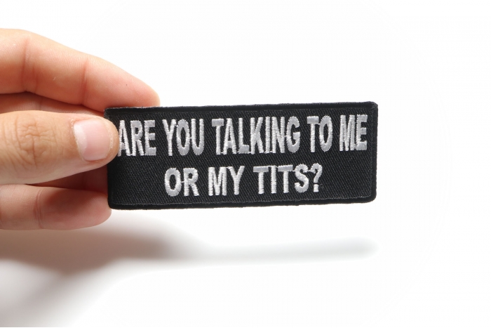Are You Talking To Me or My Tits Funny Iron on Patch shown on hand for size comparison