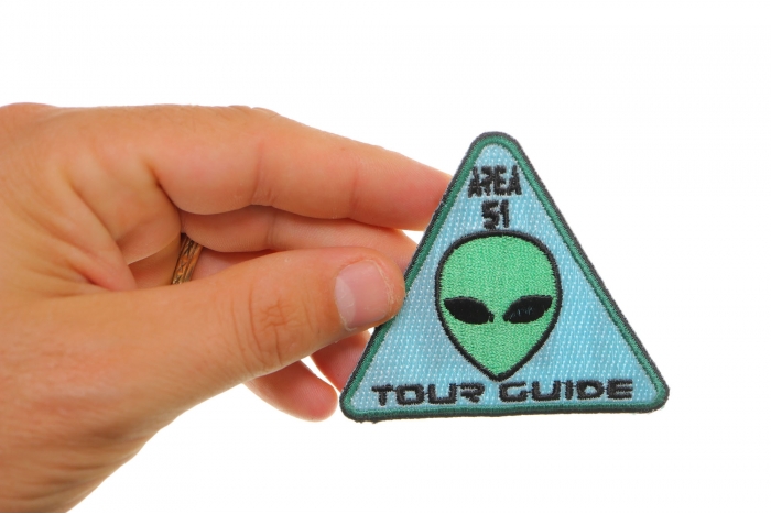 Area 51 Tour Guide Funny Iron on Patch Alien Head shown on hand for size comparison