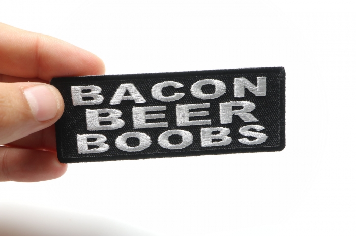 Bacon Beer Boobs Funny Iron on Patch shown on hand for size comparison