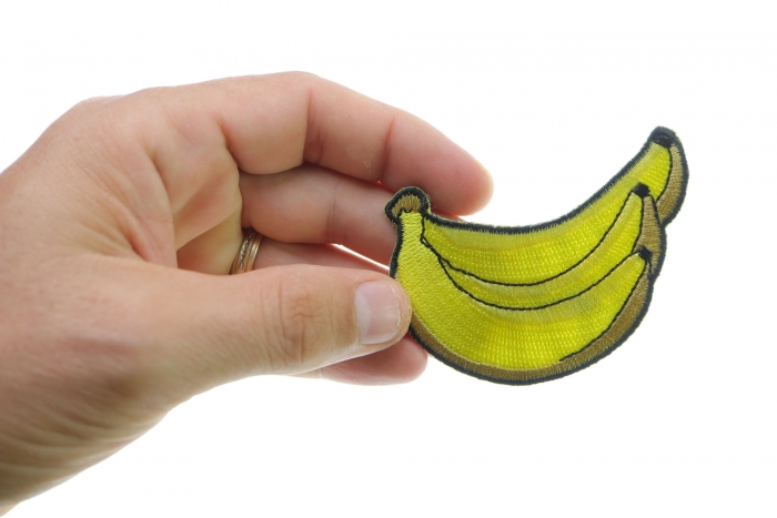 Bananas Funny Iron on Patch shown on hand for size comparison