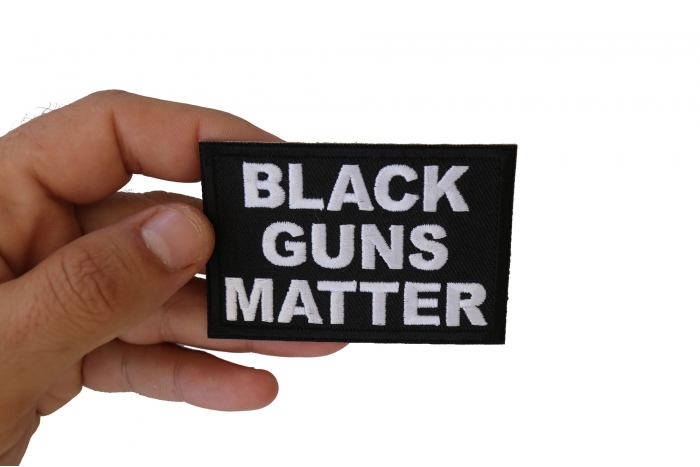 Black Guns Matter Funny Iron on Patch shown on hand for size comparison