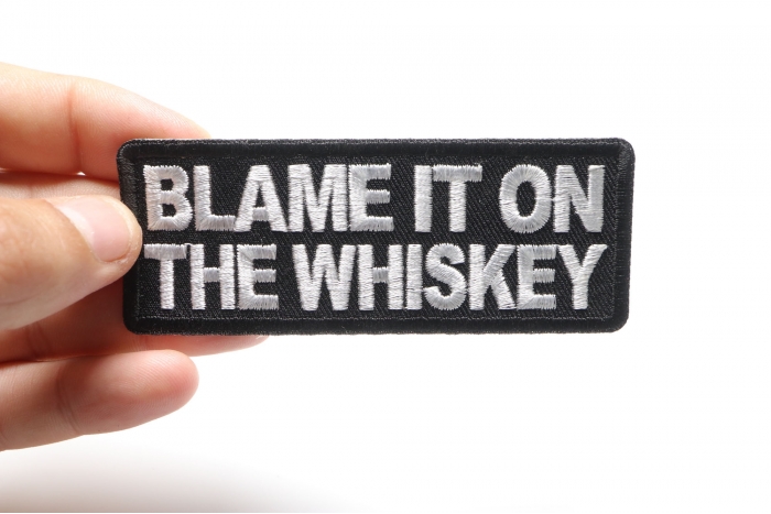 Blame it on the Whiskey Funny Iron on Patch shown on hand for size comparison