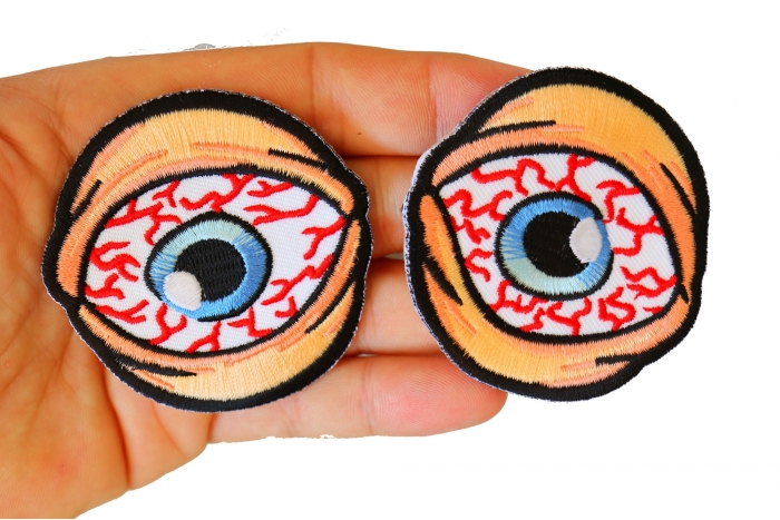 Bloodshot Eyes Funny Iron on Patch shown on hand for size comparison
