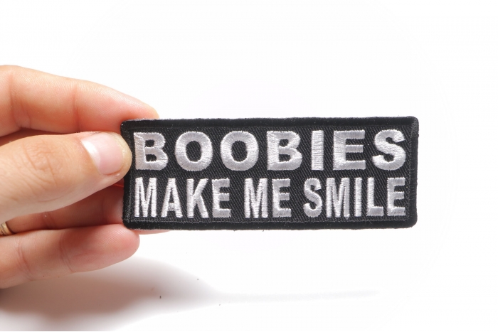 Boobies Make Me Smile Funny Iron on Patch shown on hand for size comparison
