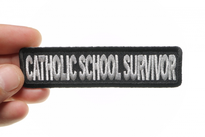 Catholic School Survivor Funny Christian Patch shown on hand for size comparison