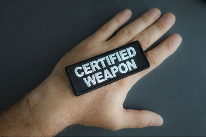 Certified Weapon Patch shown on hand for size comparison