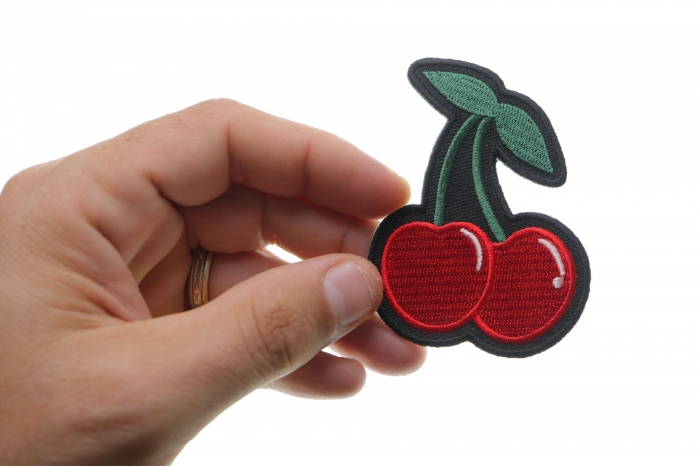Cherry Funny Iron on Patch shown on hand for size comparison