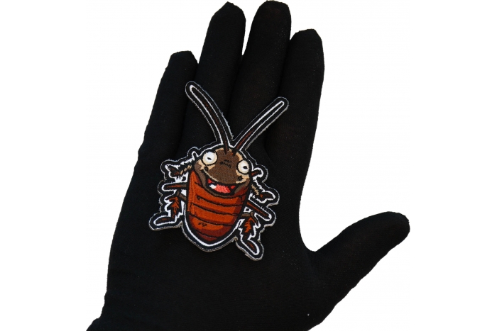 Cockroach Laugh Patch shown on hand for size comparison