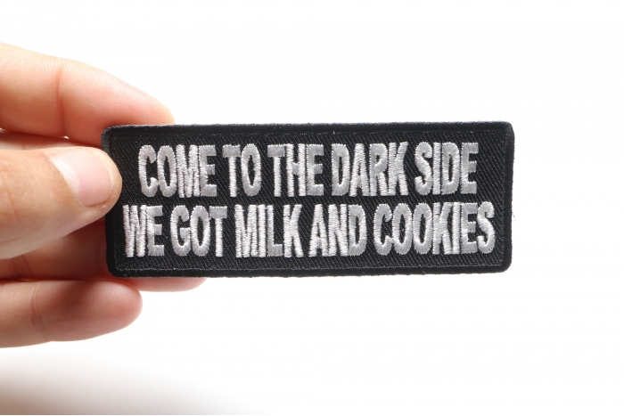 Come To The Dark Side We Have Milk and Cookies Funny Iron on Patch shown on hand for size comparison